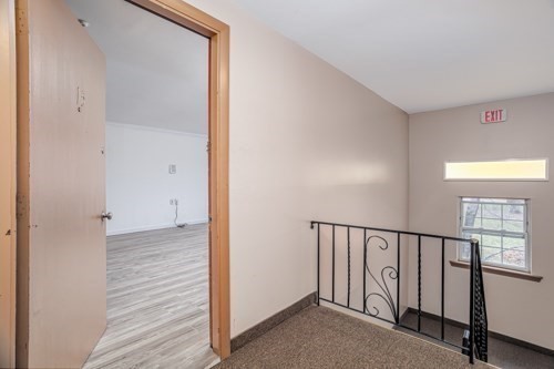 39 Berlin Street, Unit 315 Clinton, MA 01510 - Photo 2 of 22 a view of a hallway with wooden floor