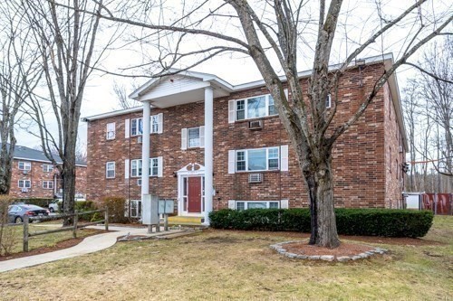 39 Berlin Street, Unit 315 Clinton, MA 01510 - Photo 21 of 22 a brick building with a large tree in front of it