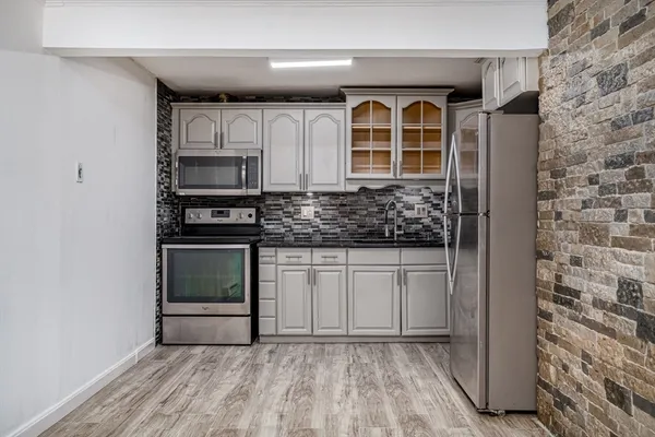 a kitchen with stainless steel appliances a refrigerator and a stove