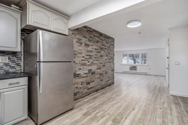 a kitchen with stainless steel appliances a refrigerator and a stove top oven