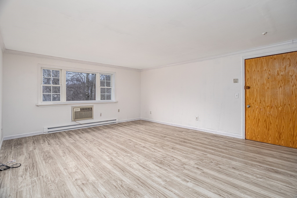 39 Berlin Street, Unit 315 Clinton, MA 01510 - Photo 6 of 22 a view of empty room with wooden floor and fan