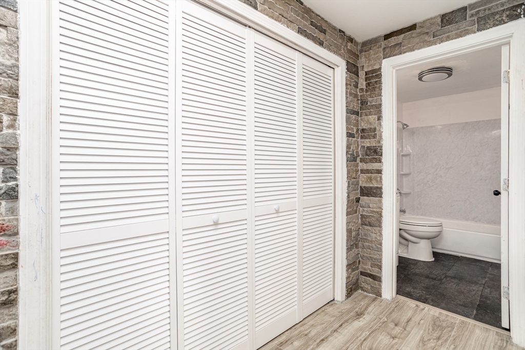 39 Berlin Street, Unit 315 Clinton, MA 01510 - Photo 10 of 22 a bathroom with a toilet a sink and a window