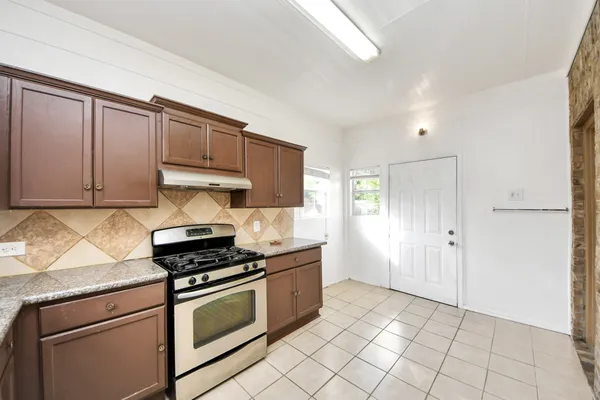 a kitchen with cabinets and appliances