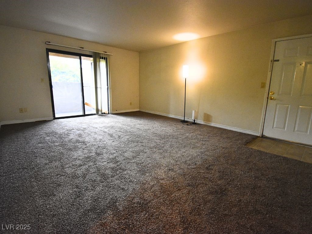 2451 North Rainbow Boulevard, Unit 1130 Las Vegas, NV 89108 - Photo 7 of 21 Spare room featuring dark colored carpet