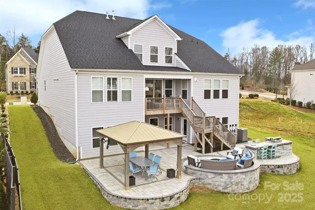 a aerial view of a house with swimming pool and furniture