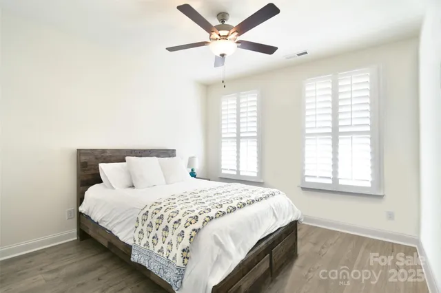 a bedroom with a large bed and a window