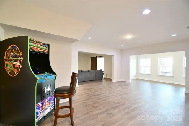 a living room with furniture a rug and a flat screen tv
