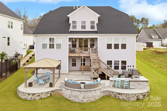 a view of a house with a fountain back yard and swimming pool