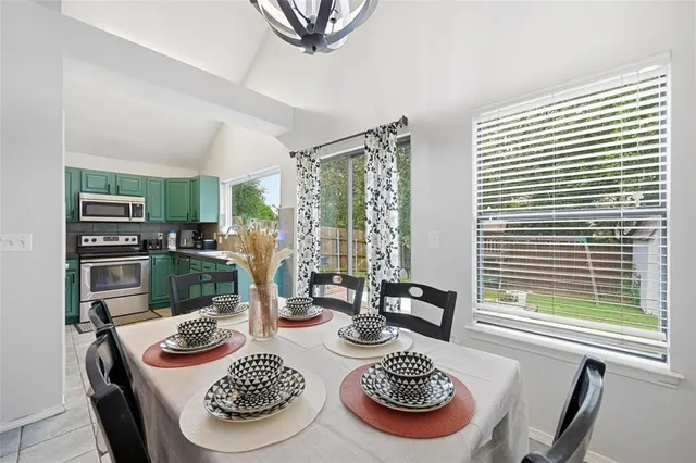 a table and chairs in a dining room with furniture