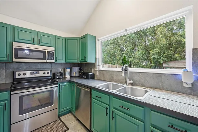 a kitchen with a sink stove and microwave