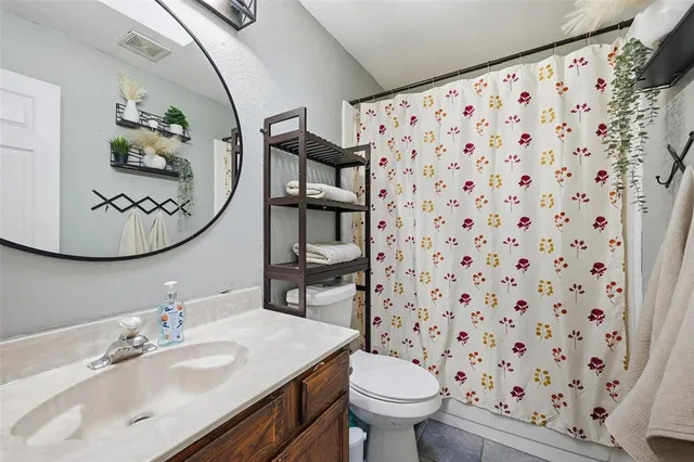 a bathroom with a sink toilet and a mirror