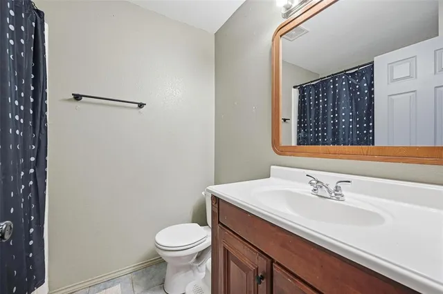 a bathroom with a sink toilet and vanity