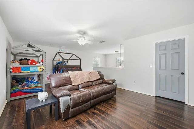 a bedroom with furniture and a wooden floor