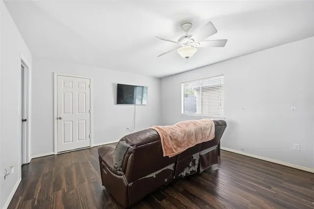 a living room with a bed furniture and a window