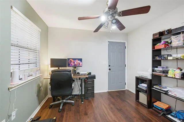 a view of a workspace with furniture and a window