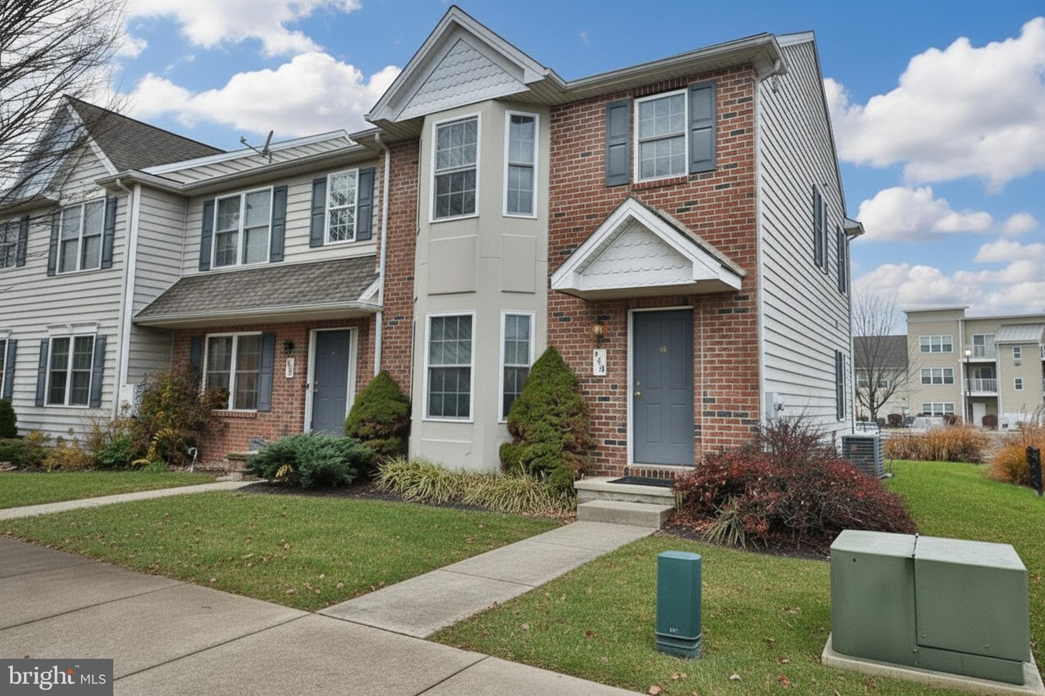 a front view of a house with a yard and porch