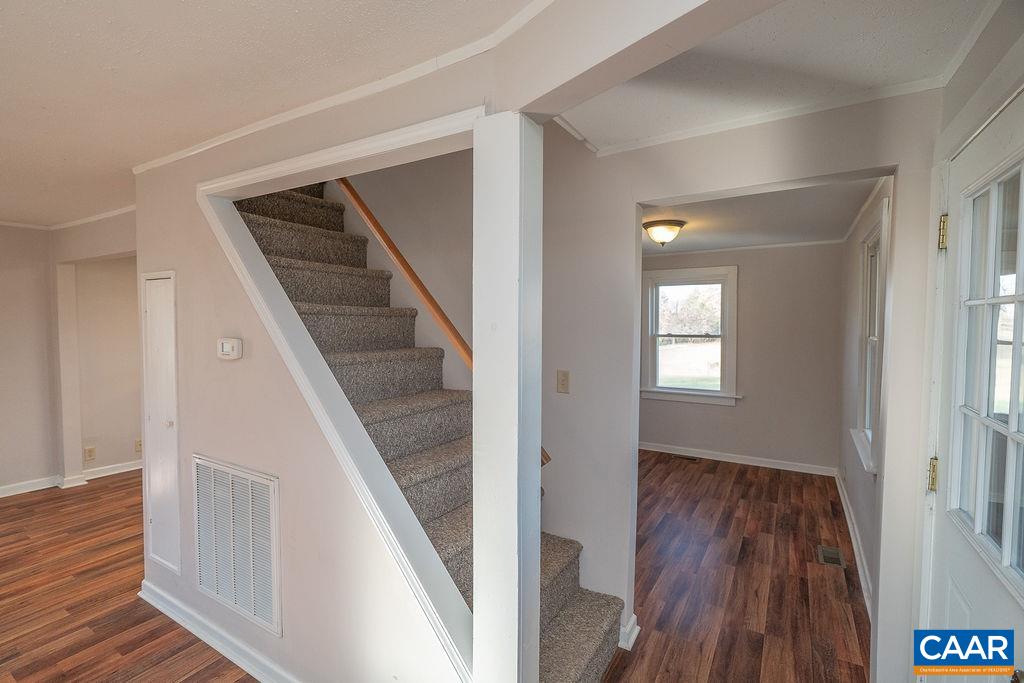 2868 Tye River Road Amherst, VA 24521 - Photo 16 of 57 a view of a hallway with wooden floor and staircase