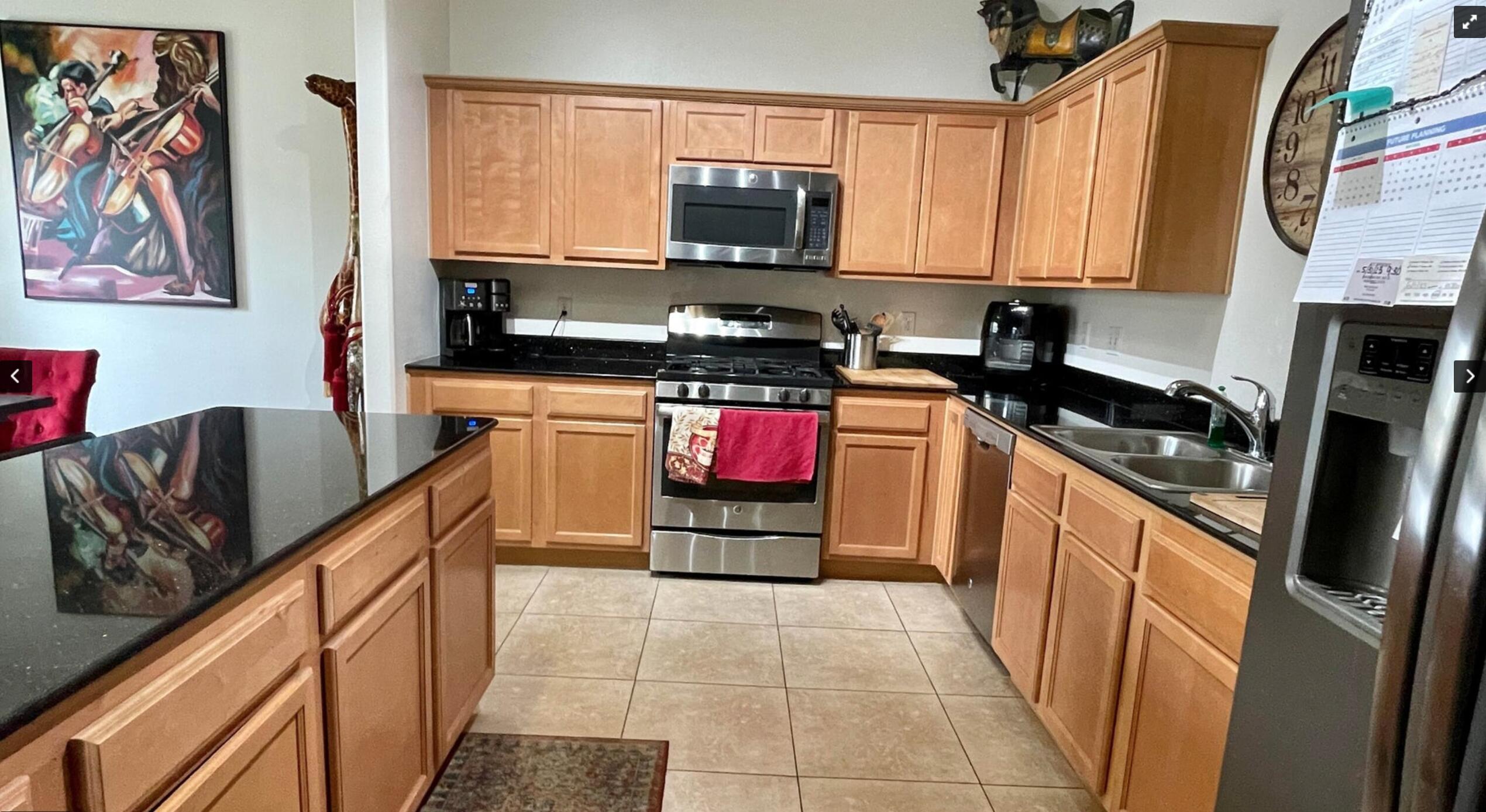 67694 Duke Road, Unit 104 Cathedral City, CA 92234 - Photo 5 of 16 a kitchen with stainless steel appliances granite countertop a stove top oven and sink