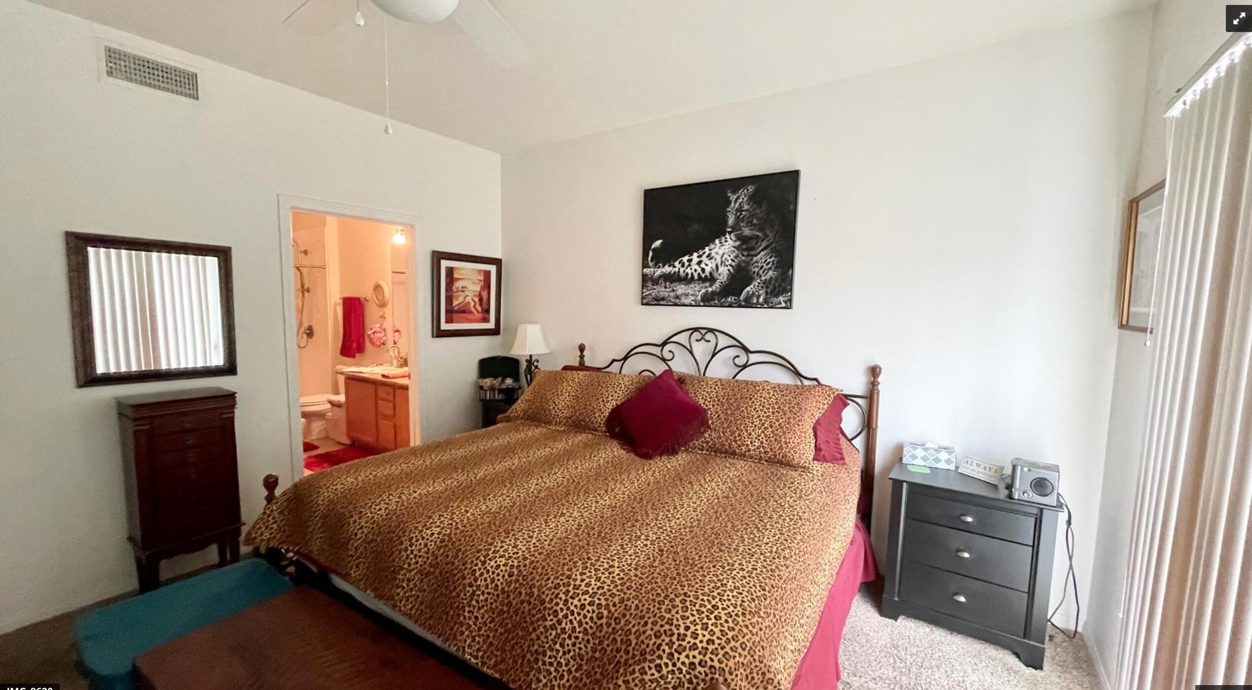 67694 Duke Road, Unit 104 Cathedral City, CA 92234 - Photo 8 of 16 a bedroom with a bed and painting on the wall