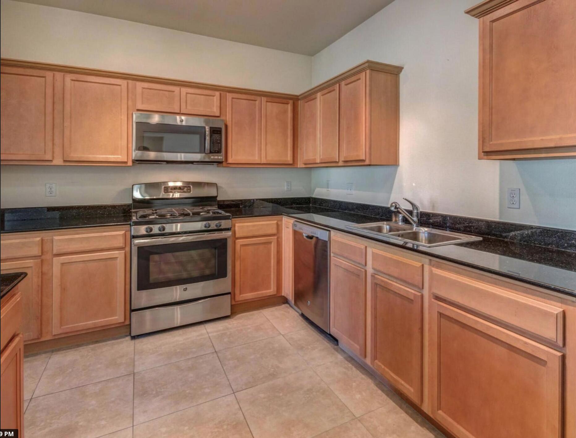 67694 Duke Road, Unit 104 Cathedral City, CA 92234 - Photo 10 of 16 a kitchen with cabinets appliances and a sink