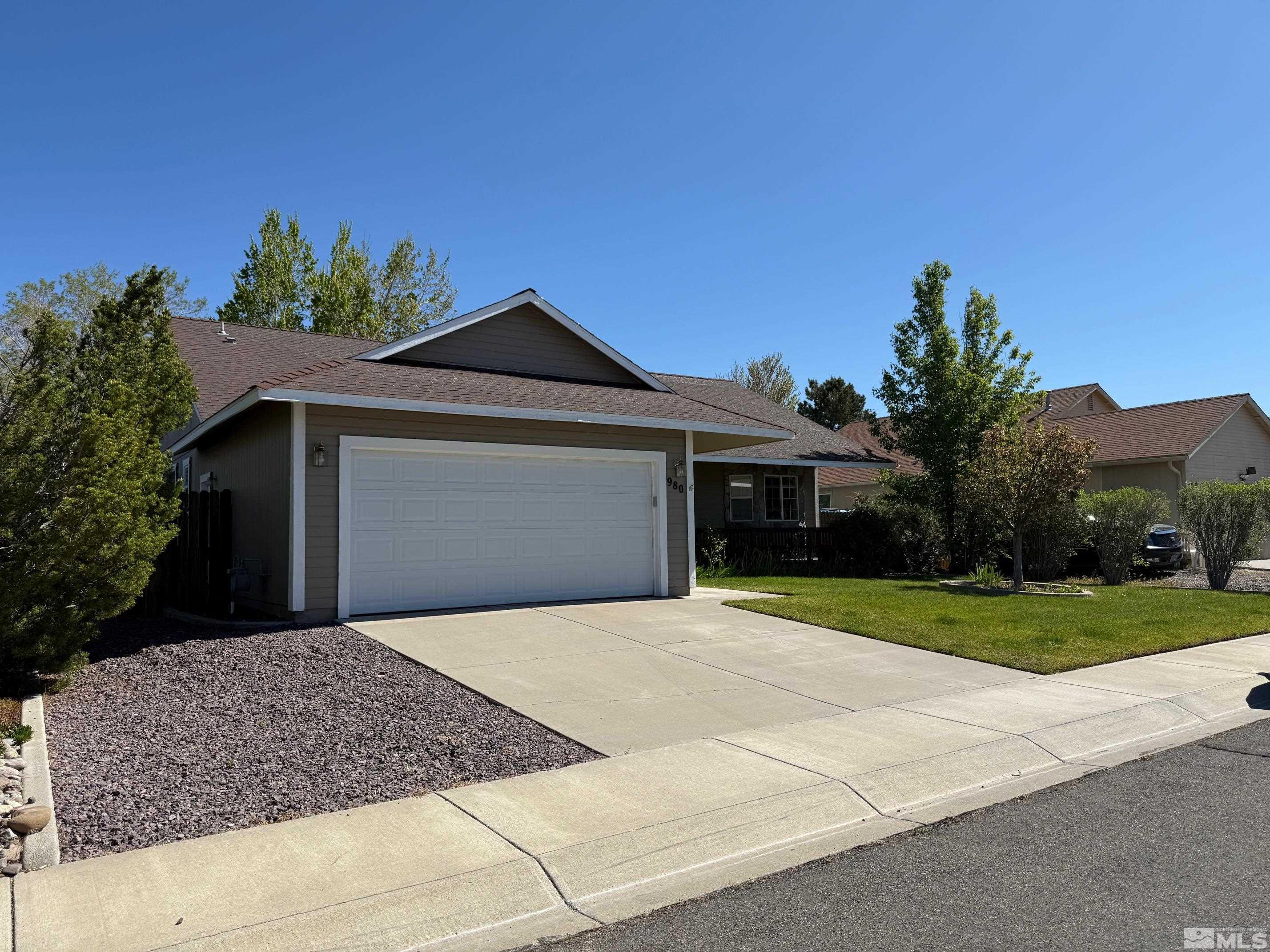980 Sunview Drive Carson City, NV 89705 - Photo 1 of 27 a front view of a house with a yard and garage