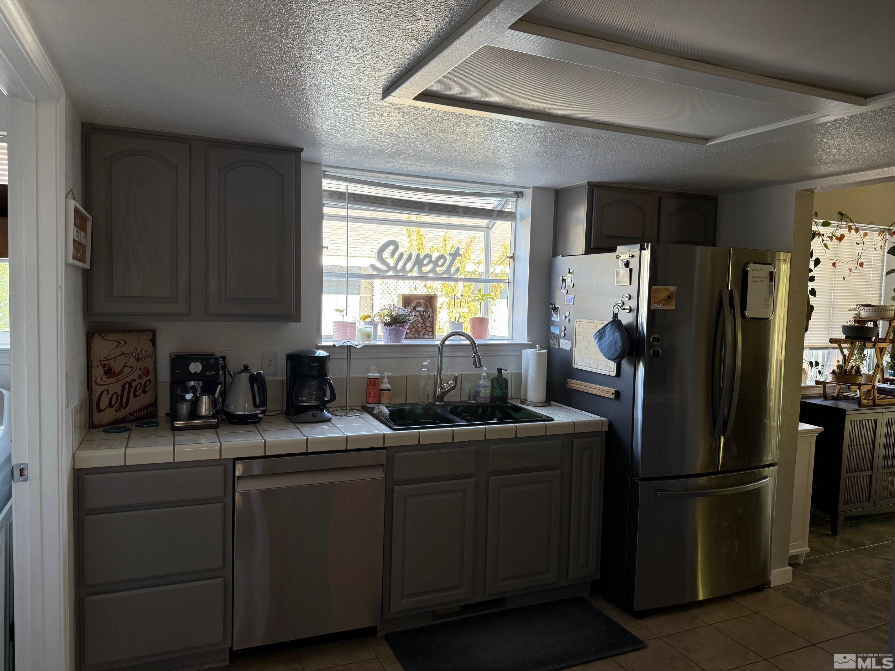 980 Sunview Drive Carson City, NV 89705 - Photo 11 of 27 a kitchen with stainless steel appliances granite countertop a refrigerator a sink a stove a cabinets and a refrigerator