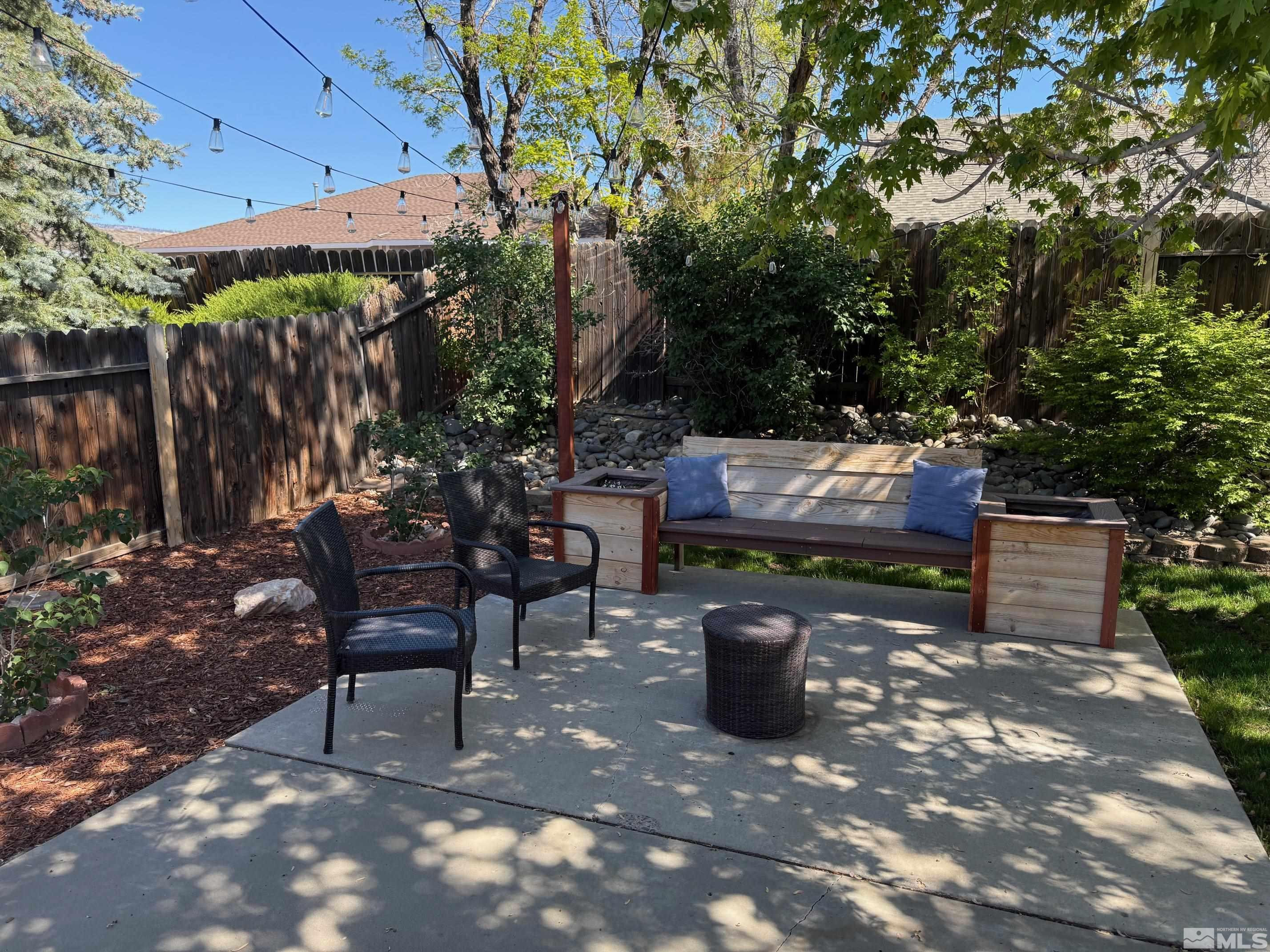 980 Sunview Drive Carson City, NV 89705 - Photo 18 of 27 a wooden bench sitting in backside of a house with potted plants and wooden fence