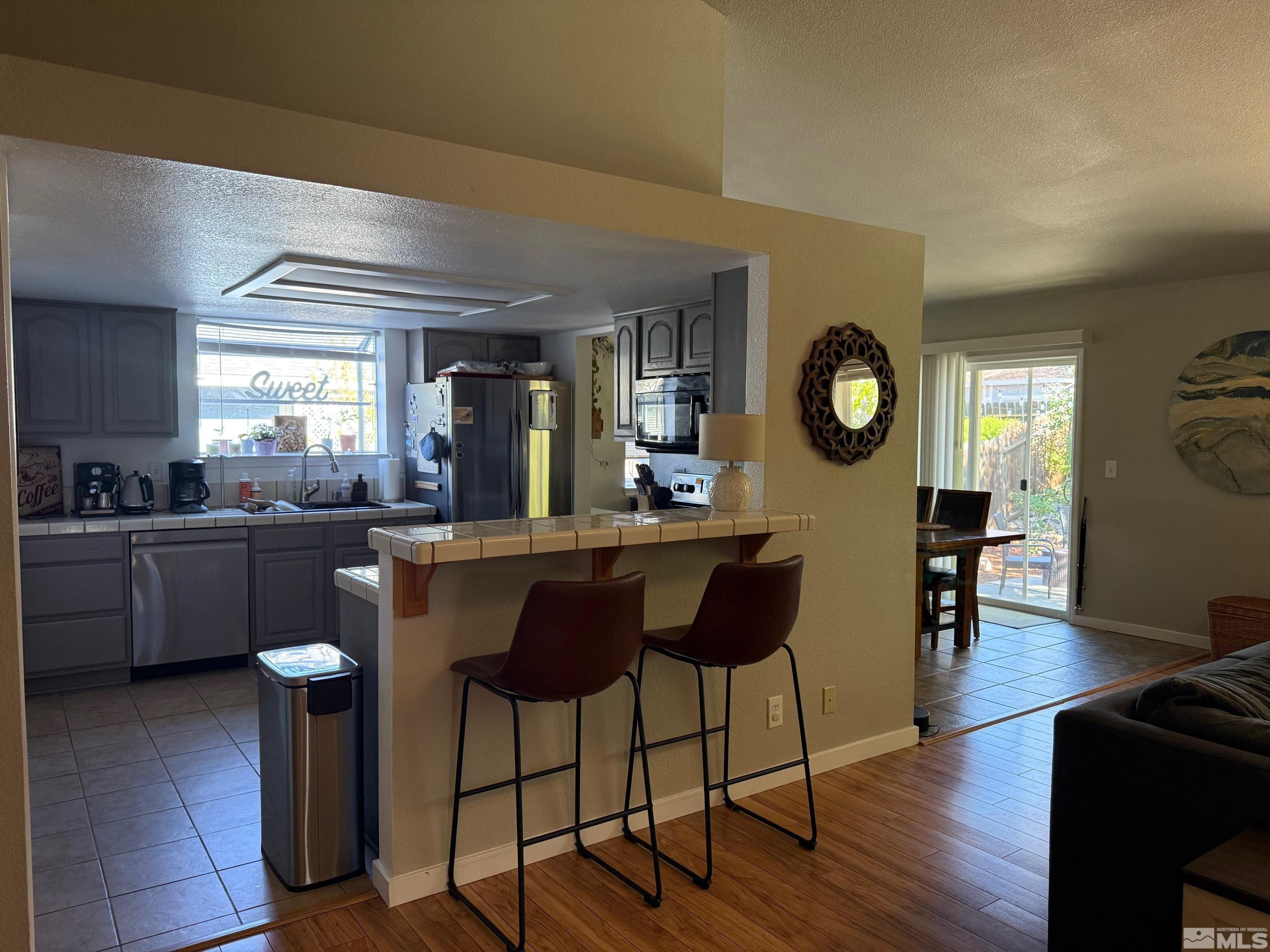 980 Sunview Drive Carson City, NV 89705 - Photo 8 of 27 a kitchen with a dining table and chairs with wooden floor
