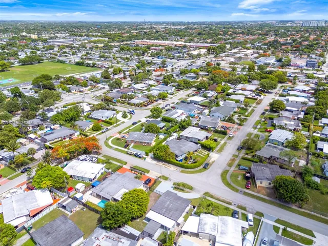 an aerial view of residential houses with outdoor space