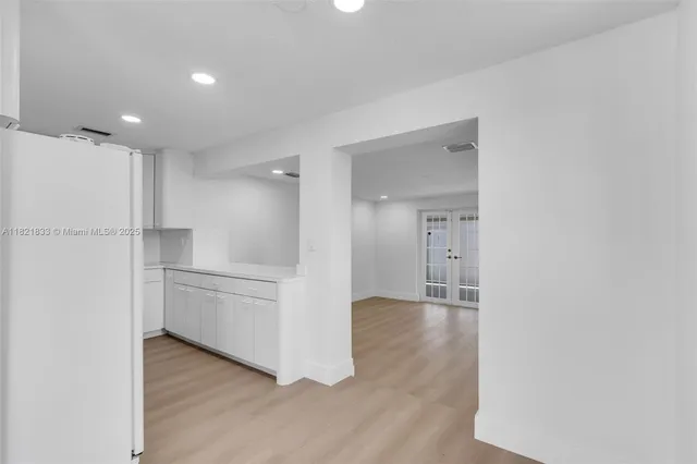 a view of a kitchen with a refrigerator and a sink