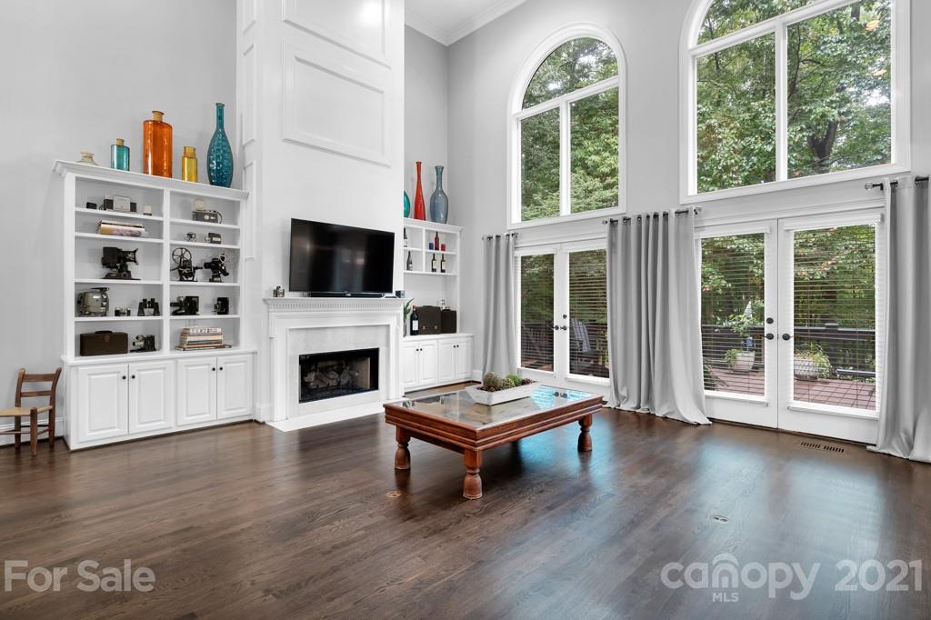 833 Amanda Drive Matthews, NC 28104 - Photo 14 of 48 a living room with furniture a fireplace and a floor to ceiling window