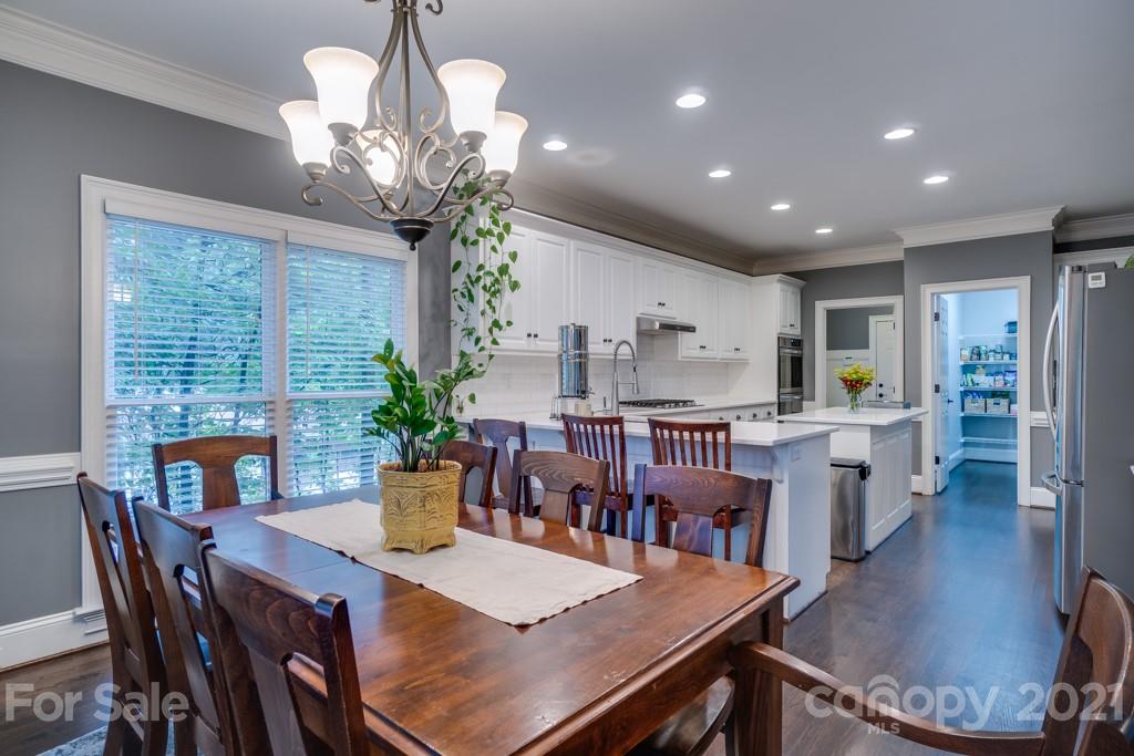 833 Amanda Drive Matthews, NC 28104 - Photo 18 of 48 a view of a dining room with furniture a chandelier and wooden floor