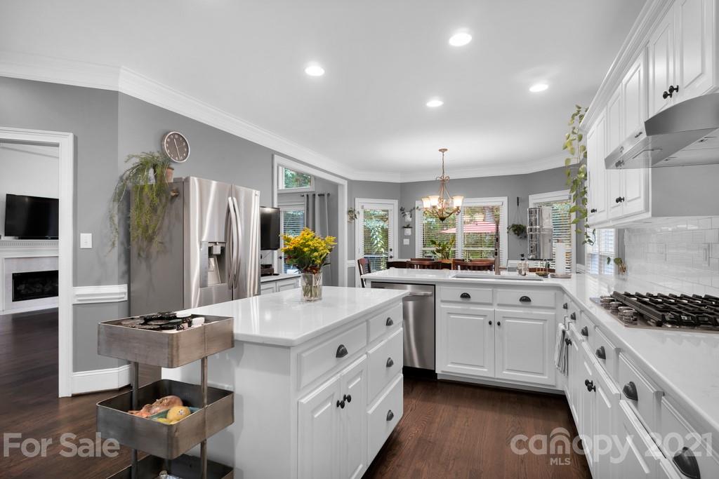 833 Amanda Drive Matthews, NC 28104 - Photo 22 of 48 a large white kitchen with stainless steel appliances kitchen island granite countertop a lot of counter space and a sink