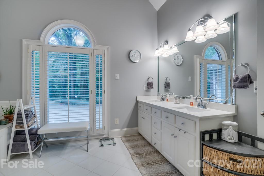 833 Amanda Drive Matthews, NC 28104 - Photo 33 of 48 a bathroom with a sink a toilet a mirror and window