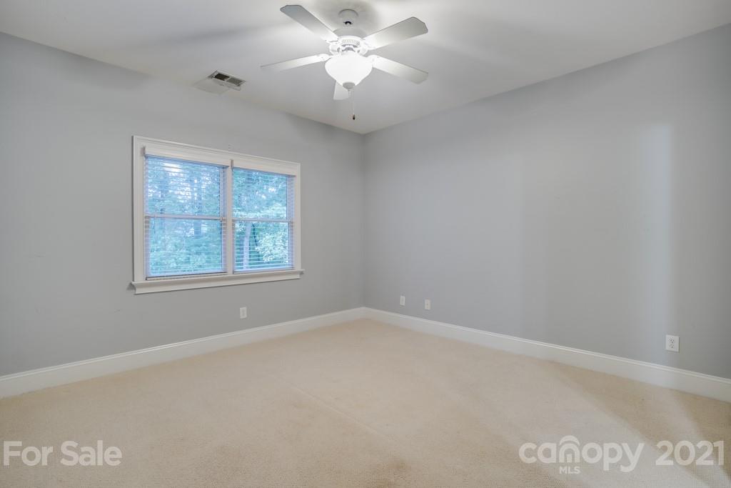 833 Amanda Drive Matthews, NC 28104 - Photo 37 of 48 an empty room with a window and a fan