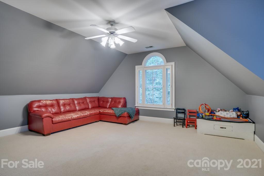 833 Amanda Drive Matthews, NC 28104 - Photo 43 of 48 a living room with furniture and a chandelier