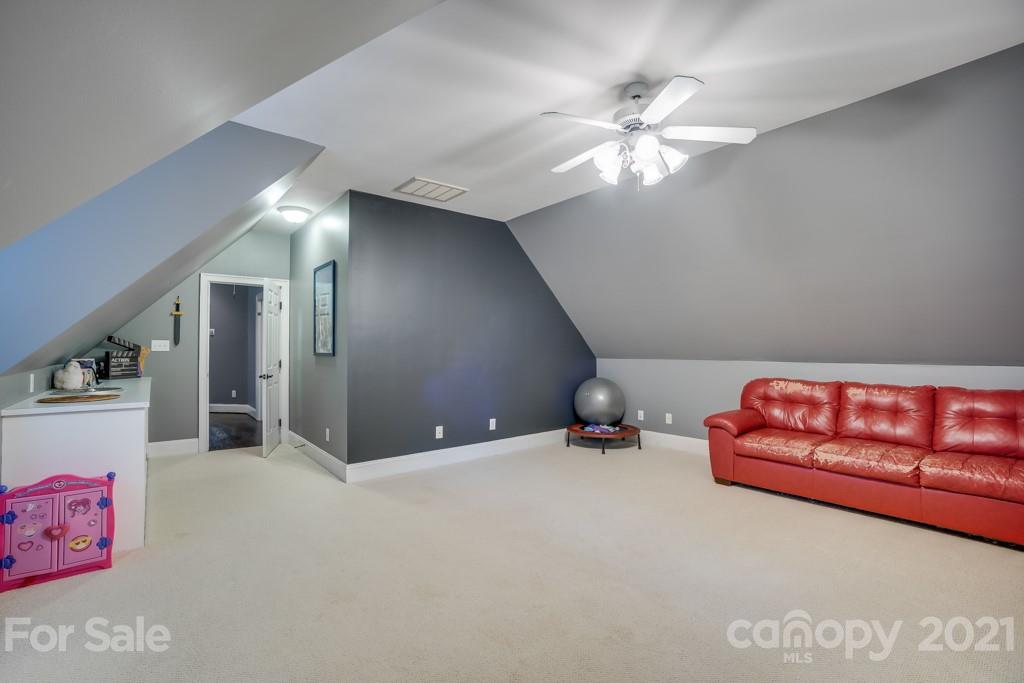 833 Amanda Drive Matthews, NC 28104 - Photo 44 of 48 a furnished livingroom with a ceiling fan and window