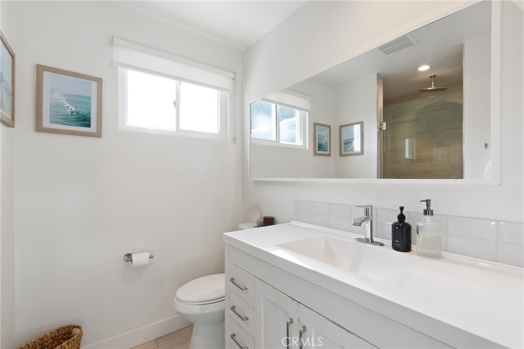 7901 Flight Los Angeles, CA 90045 - Photo 13 of 24 a bathroom with a sink a toilet and a mirror