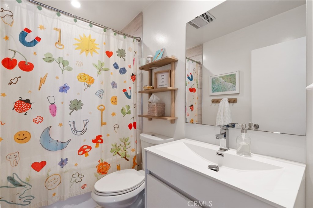 7901 Flight Los Angeles, CA 90045 - Photo 16 of 24 a bathroom with a sink and a white curtain with a shower curtain