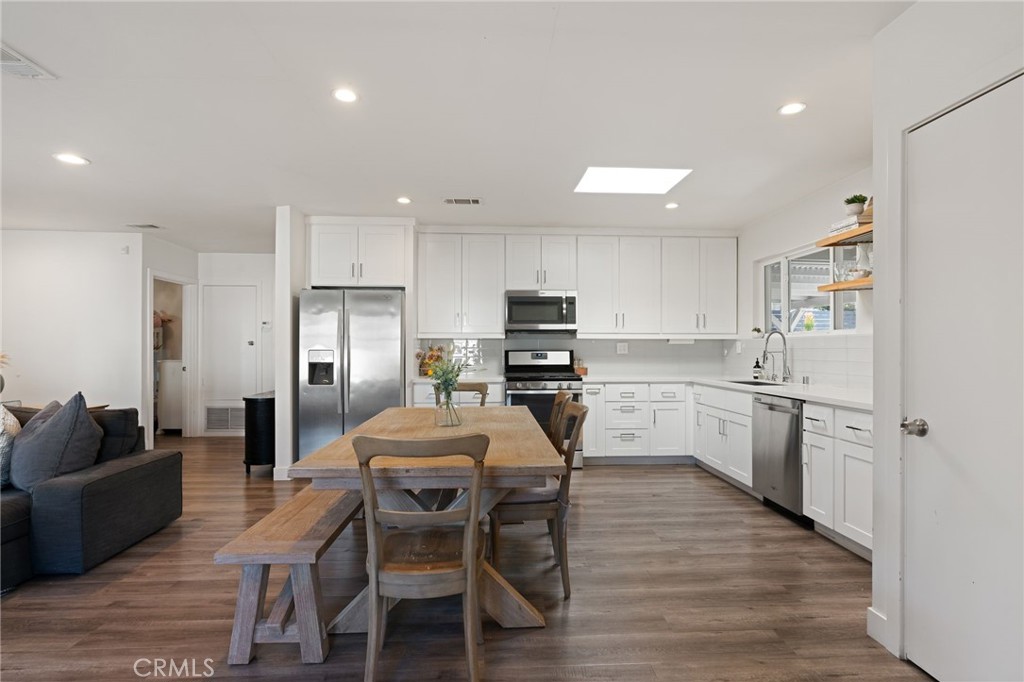 7901 Flight Los Angeles, CA 90045 - Photo 7 of 24 a kitchen with refrigerator a sink and chairs