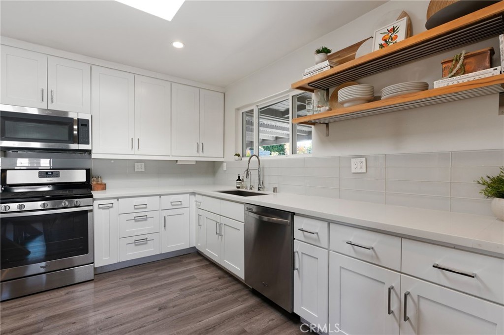 7901 Flight Los Angeles, CA 90045 - Photo 8 of 24 a kitchen with stainless steel appliances granite countertop a stove a sink and white cabinets