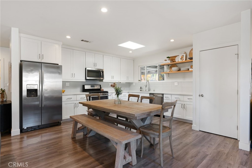 7901 Flight Los Angeles, CA 90045 - Photo 9 of 24 a kitchen with stainless steel appliances a dining table chairs and wooden floor