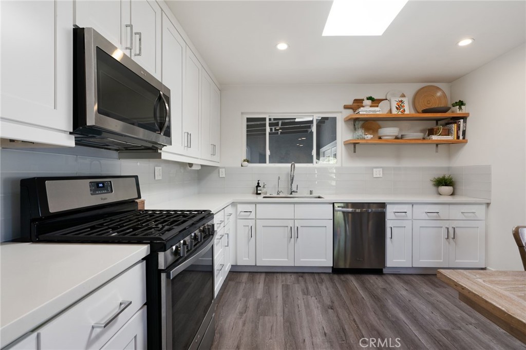7901 Flight Los Angeles, CA 90045 - Photo 10 of 24 a kitchen with stainless steel appliances granite countertop a stove and a sink