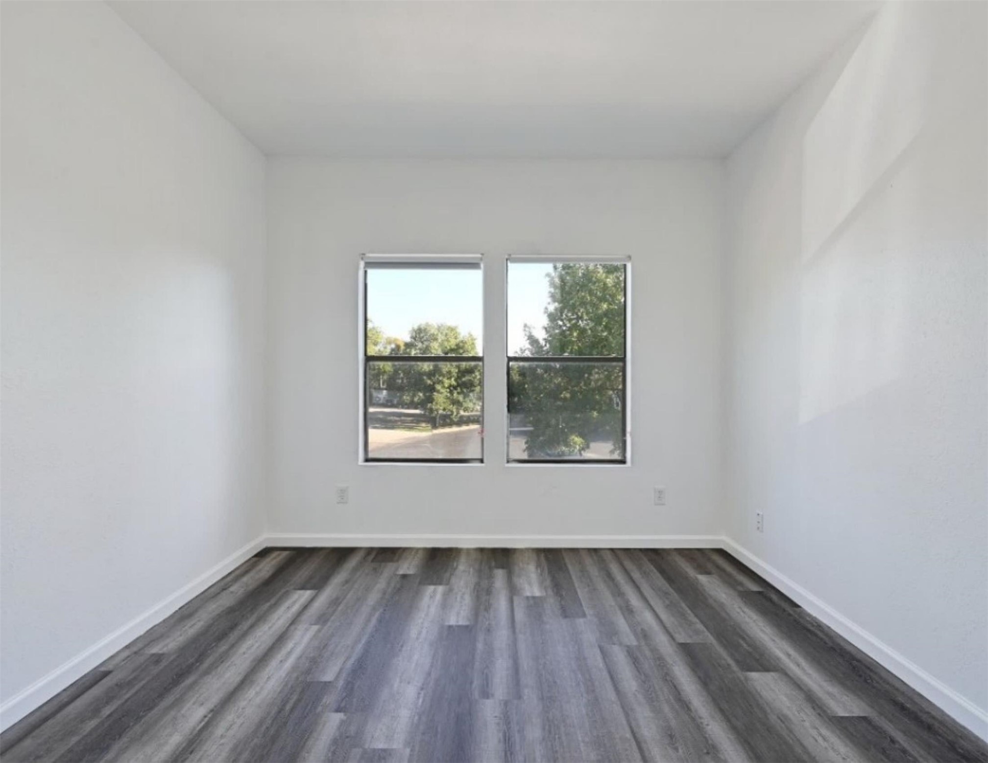 9508 Kempler Drive, Unit B Austin, TX 78748 - Photo 7 of 12 an empty room with wooden floor and windows