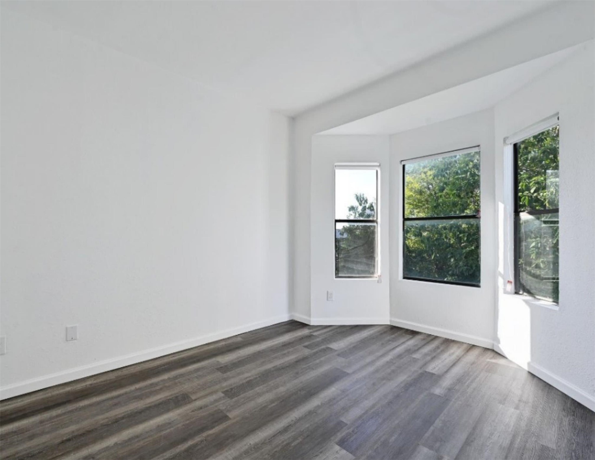9508 Kempler Drive, Unit B Austin, TX 78748 - Photo 9 of 12 an empty room with wooden floor and windows