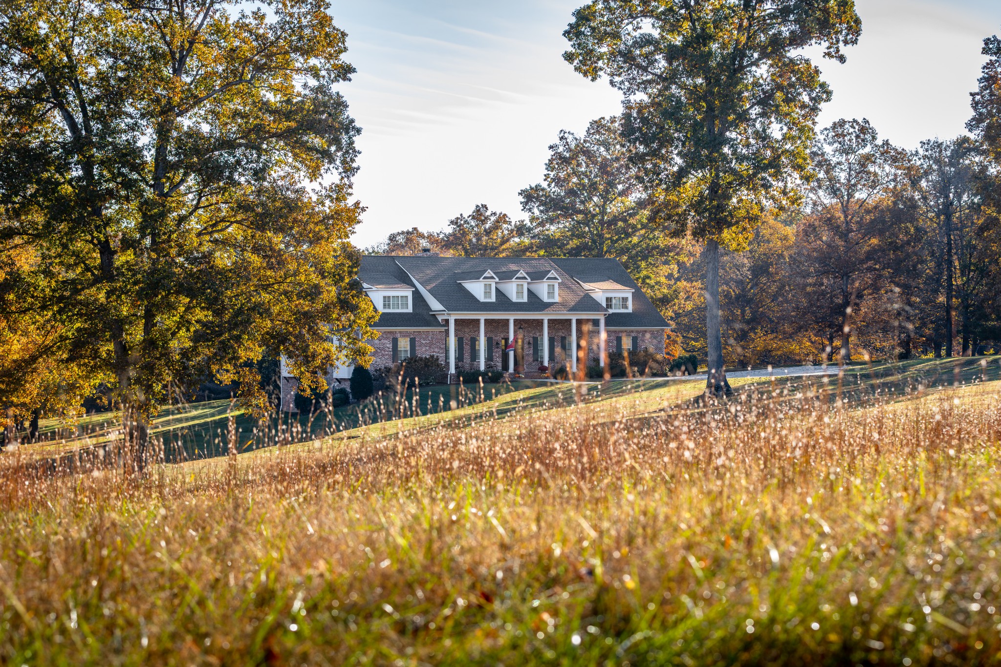 a view of house with outdoor space and sitting area