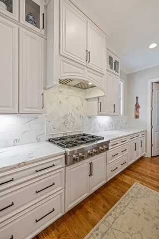 a kitchen with granite countertop a stove and a sink
