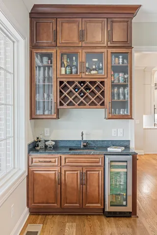 a bathroom with a double vanity sink mirror and bathtub