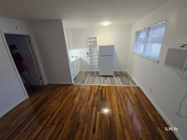 a view of a room with wooden floor and fan