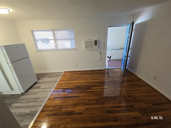 a view of a room with wooden floor